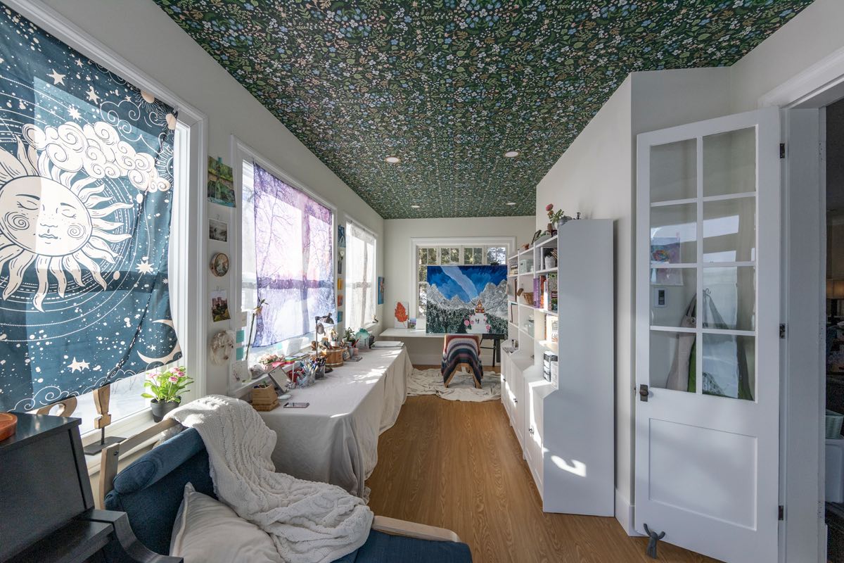 Sun Porch Remodel in a Fargo/Moorhead historic home. Art studio space with a wallpapered ceiling, refinished hardwood floors, and new windows/doors.